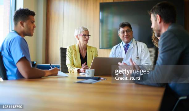 hospital admin meeting - medical authority stock pictures, royalty-free photos & images
