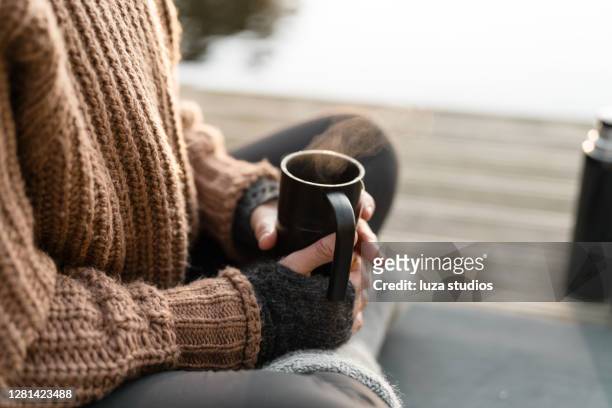steaming hot tea in the sun on an autumn day - cardigan stock pictures, royalty-free photos & images