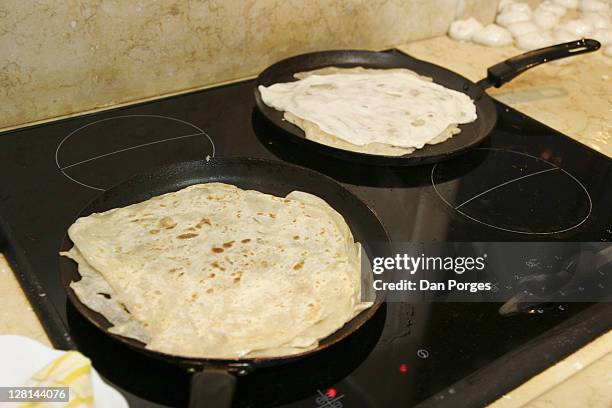 making mufletas for the holiday mimouna, traditional north african jewish celebration held the day after passover. fried dough eaten with butter and honey. jerusalem. israel - mimouna stock pictures, royalty-free photos & images