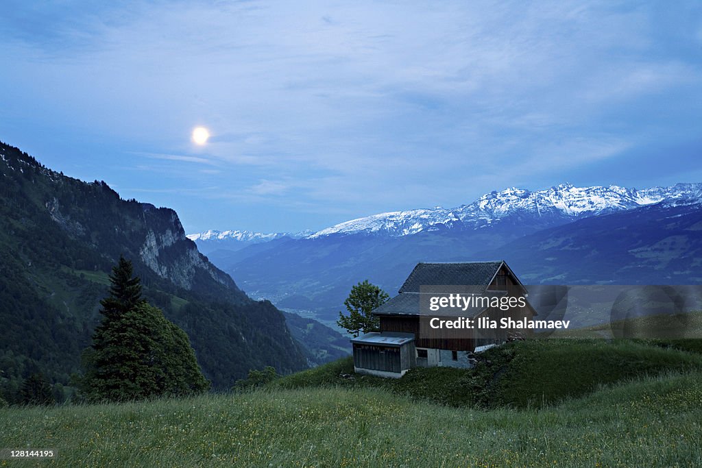 Moonrise over alpine hut, Heidiland, Swiss Alps, Switzerland