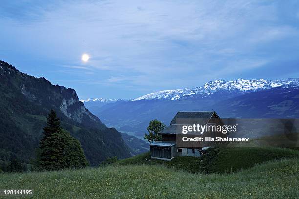 moonrise over alpine hut, heidiland, swiss alps, switzerland - heidiland stock pictures, royalty-free photos & images