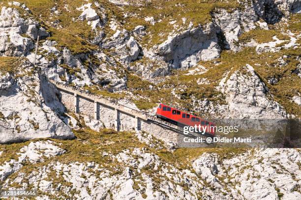 the famous cogwheel train climbing to the top of mount pilatus in canton lucerne in switzerland - switzerland train stock pictures, royalty-free photos & images