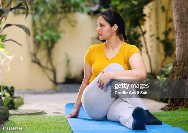 woman doing exercise and yoga asana. - annual woman stock pictures, royalty-free photos & images