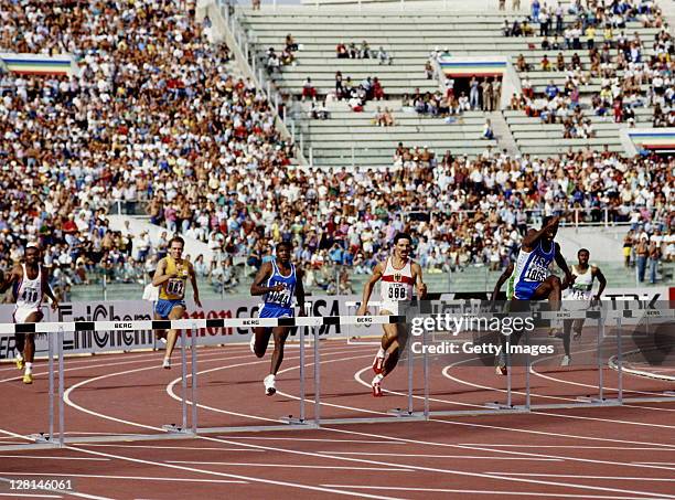 Edwin Moses of the United States clears the hurdle ahead of compatriot Danny Harris and Harald Schmid of West Germany during the Men's 400 metres...