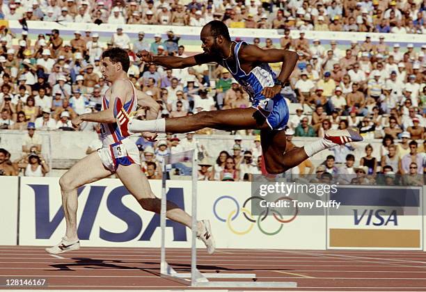 Edwin Moses of the United States clears the hurdle ahead of Martin Gillingham of Great Britain during the heats for the Men's 400 metres hurdles...