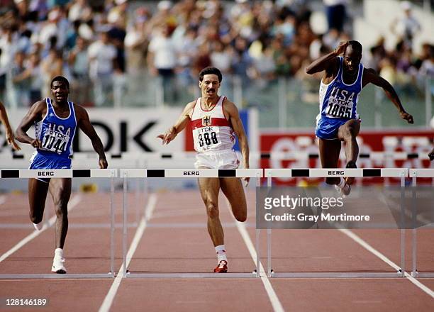 Edwin Moses of the United States clears the hurdle ahead of compatriot Danny Harris and Harald Schmid of West Germany during the Men's 400 metres...