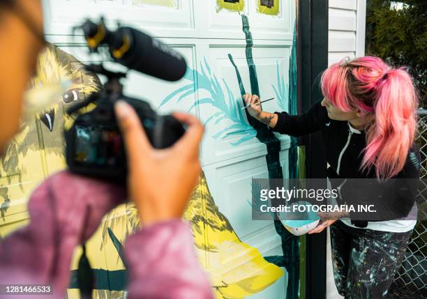 female mural artist at work - documentary stock pictures, royalty-free photos & images