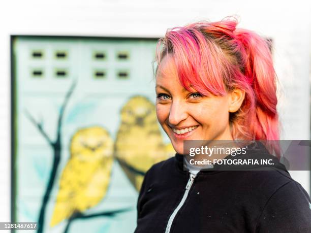 female mural artist at work - young woman painting wall stock pictures, royalty-free photos & images