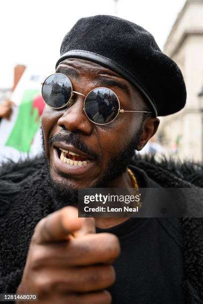 Protester gestures towards the media as he marches with a demonstration calling for the end of police violence against the public in Nigeria, on...