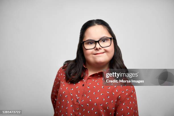 portrait of a young confident female adult with down syndrome - differing abilities female business stock-fotos und bilder