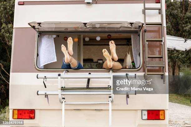 feet of a couple on a window - stock photo - caravan stock-fotos und bilder