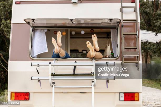 feet of a couple on a window - stock photo - roulotte foto e immagini stock