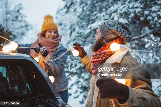 perfect christmas tree is arrived - woman snow outside night stock pictures, royalty-free photos & images