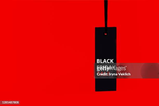 sale tag on the red background. black friday concept.. - f��retag bildbanksfoton och bilder