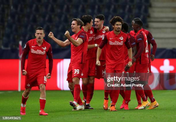 Dominik Szoboszlai of RB Salzburg celebrates with teammates after scoring his team's first goal during the UEFA Champions League Group A stage match...
