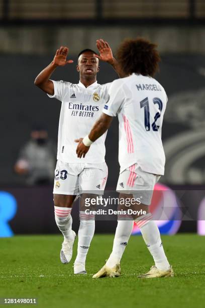 Vinicius Junior of Real Madrid celebrates with teammate Marcelo after scoring his sides second goal during the UEFA Champions League Group B stage...