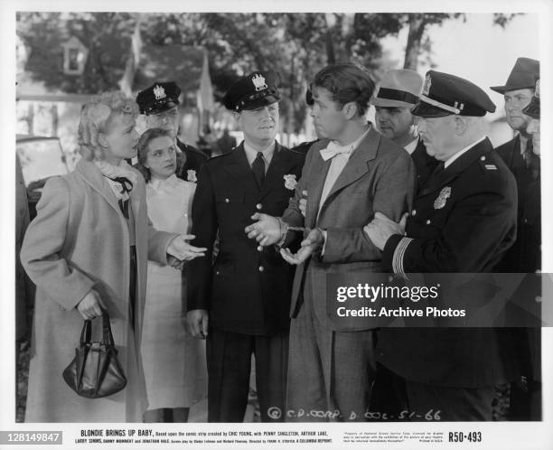 Penny Singleton questions arrested Arthur Lake in a scene from the film 'Blondie Brings Up Baby', 1939.