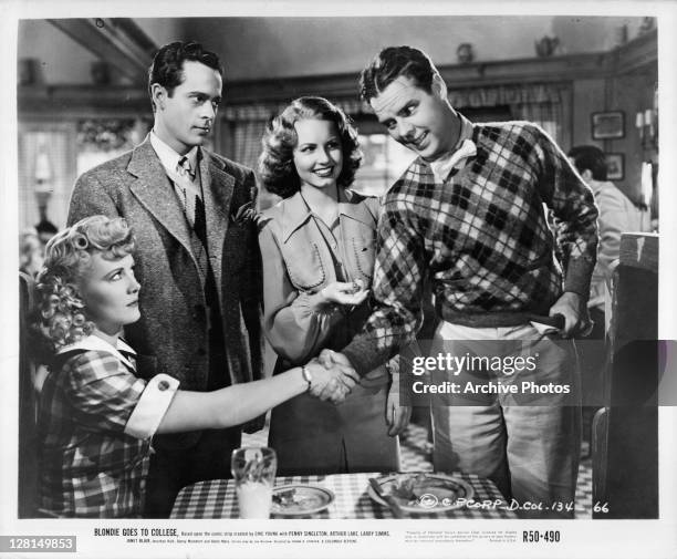 Penny Singleton and Arthur Lake shake hands in a scene from the film 'Blondie Goes To College', 1942.