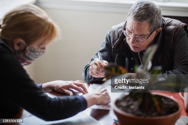 social worker having a discussion with a senior man to establish what his homecare needs are, in order to make his life as comfortable as possible. - nasal cannula stock pictures, royalty-free photos & images