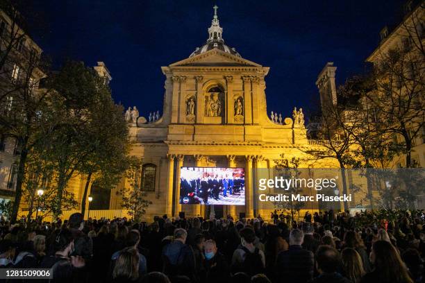 People gather on the Place de la Sorbonne during the National Tribute to the murdered school teacher Samuel Paty on October 21, 2020 in Paris,...