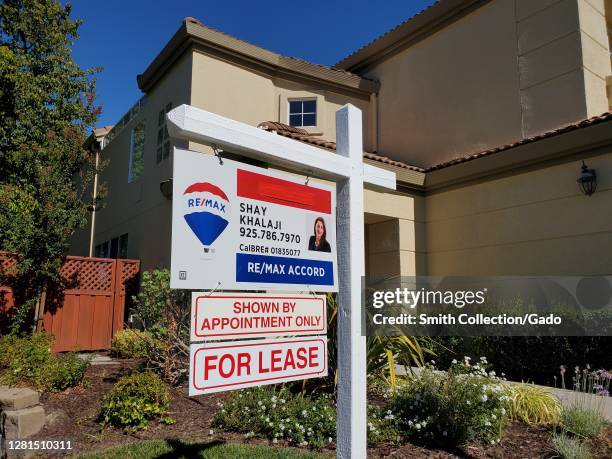 Close-up of logo for realtor Remax on sign in suburban neighborhood, San Ramon, California, with sign reading For Lease, October 14, 2020.