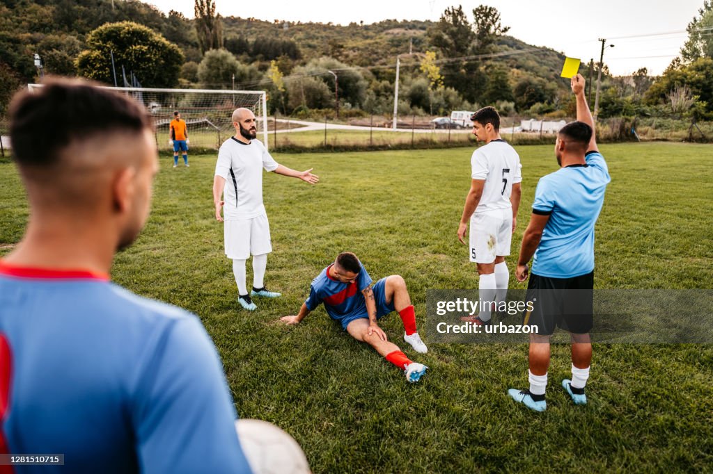 Soccer referee showing yellow card