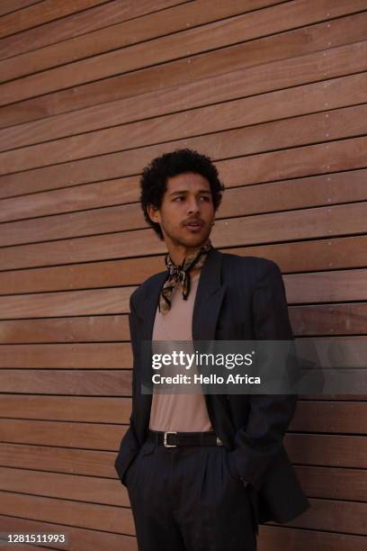 portrait of a handsome elegantly dressed young man looking aside with his hands in his pockets - silk scarves stock pictures, royalty-free photos & images