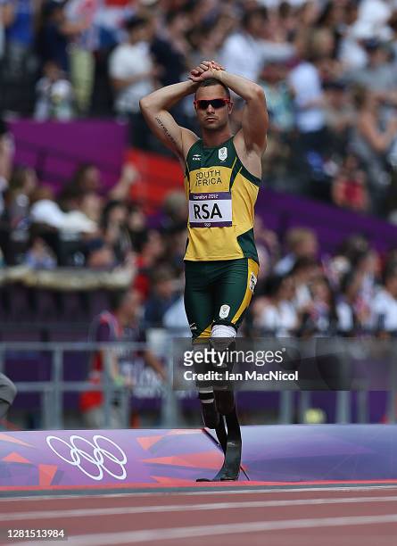 Oscar Pistorius of South Africa reacts when he realises team mate Ofentse Mogawane has pulled up during the heats of the men's 4x400m relays , during...