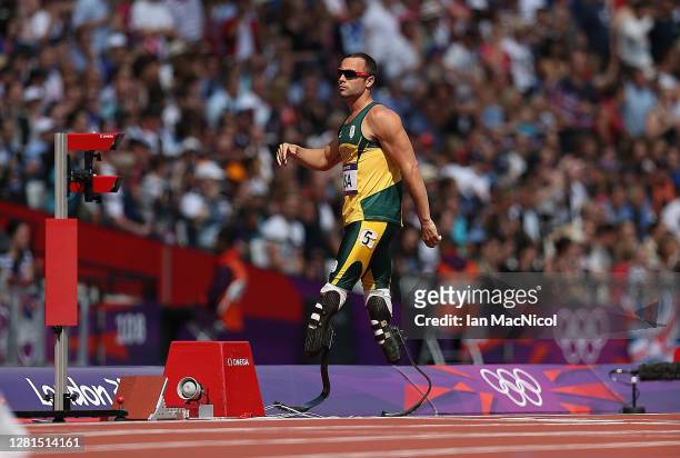 Oscar Pistorius of South Africa reacts when he realises team mate Ofentse Mogawane has pulled up during the heats of the men's 4x400m relays , during...