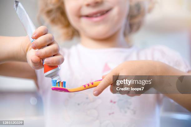 cleaning teeth - toothpaste stock pictures, royalty-free photos & images