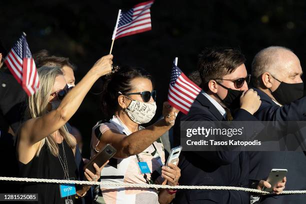 Supporters cheer on President Donald Trump outside the White House on October 21, 2020 in Washington, DC. President Trump is headed to a rally in...