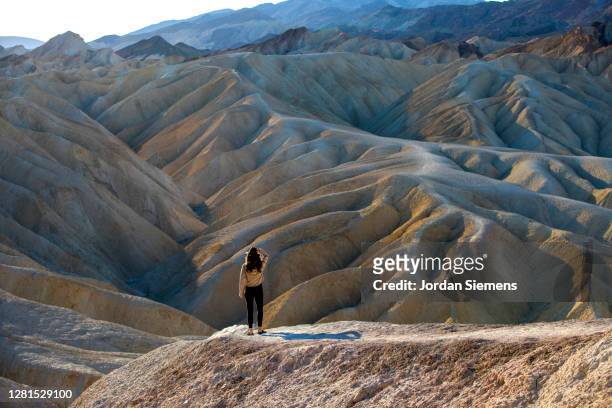 a woman standing on a viewpoint in death valley. - nevada stock pictures, royalty-free photos & images