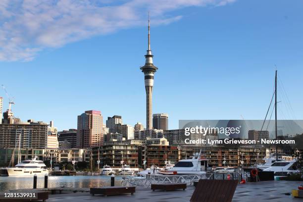 The evening sun hits the Sky Tower in Auckland, New Zealand, seen from the Lighter Basin, Viaduct Harbour, on October 17 the night of the 2020...