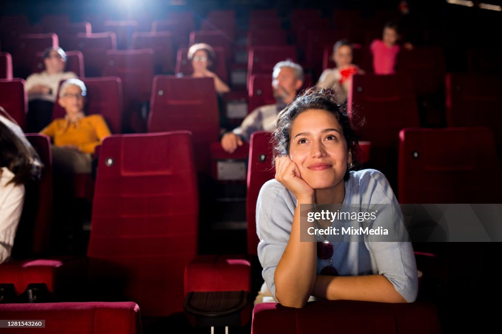 Portrait of a young woman enjoying a romantic movie at the cinema