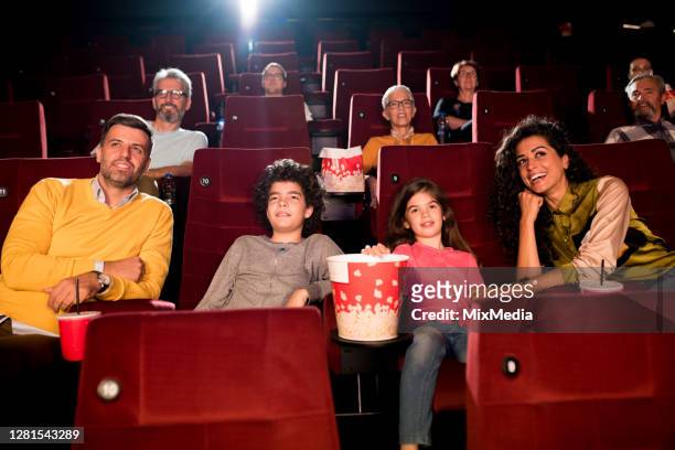 family watching a movie at the cinema - girls boys opening night stock pictures, royalty-free photos & images