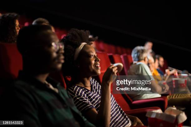 african-american couple enjoying at the cinema - red carpet movie stock pictures, royalty-free photos & images