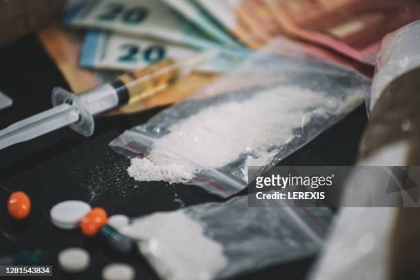 cocaine and other drugs on the table for the addict - drugs stockfoto's en -beelden