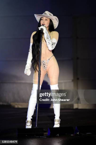 In this image released on October 21, Noah Cyrus performs onstage at the Bicentennial Mall in Nashville, Tennessee for the 2020 CMT Awards, broadcast...