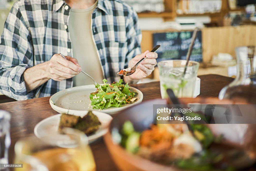 Japanese man eating a vegan lunch at a vegan cafe