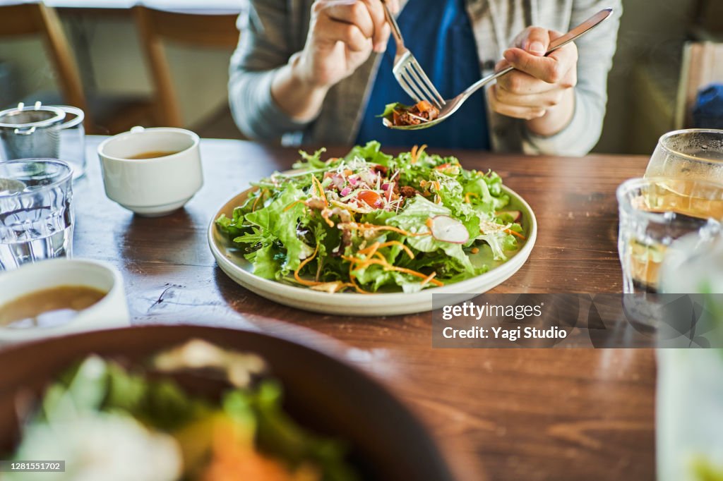 Japanese woman eating a vegan lunch at a vegan cafe