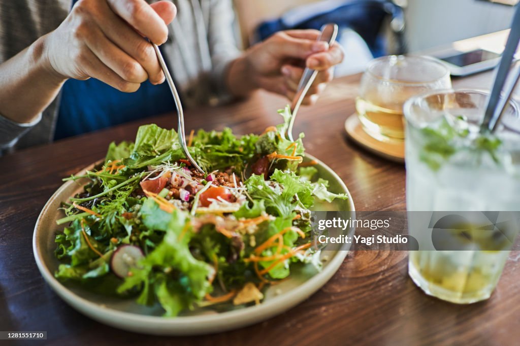Japanese woman eating a vegan lunch at a vegan cafe