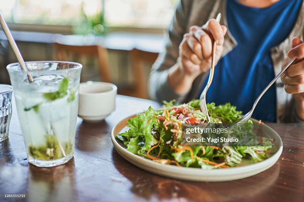 Japanese woman eating a vegan lunch at a vegan cafe