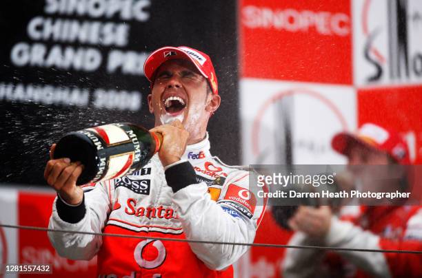 British McLaren Formula One driver Lewis Hamilton celebrates on the winners podium by spraying champagne after finishing first at the 2008 Chinese...
