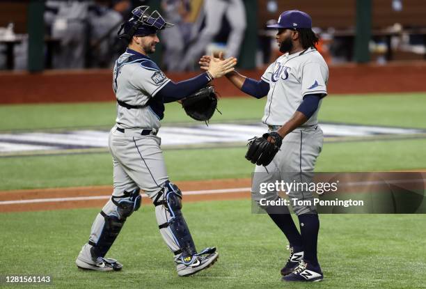 Mike Zunino and Diego Castillo of the Tampa Bay Rays celebrate the teams 6-4 victory against the Los Angeles Dodgers in Game Two of the 2020 MLB...