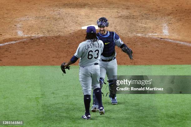 Mike Zunino and Diego Castillo of the Tampa Bay Rays celebrate the teams 6-4 victory against the Los Angeles Dodgers in Game Two of the 2020 MLB...