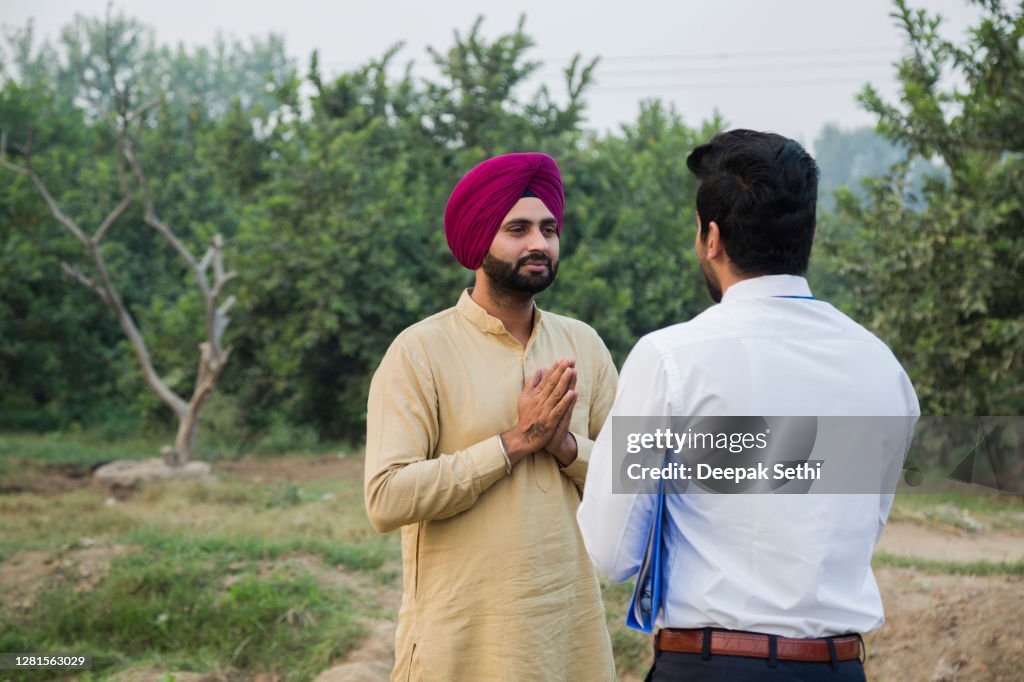 Real estate agent with client at village stock photo