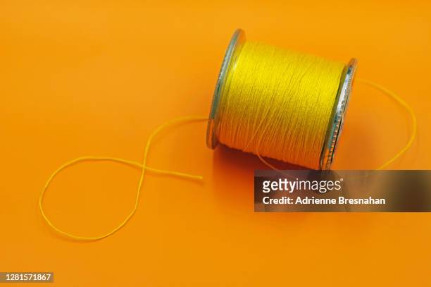 yellow spool of thread - thread sewing item stock-fotos und bilder
