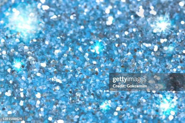 blue glitter abstract christmas background. blue blur bokeh lights, defocused background. - bling background stock illustrations