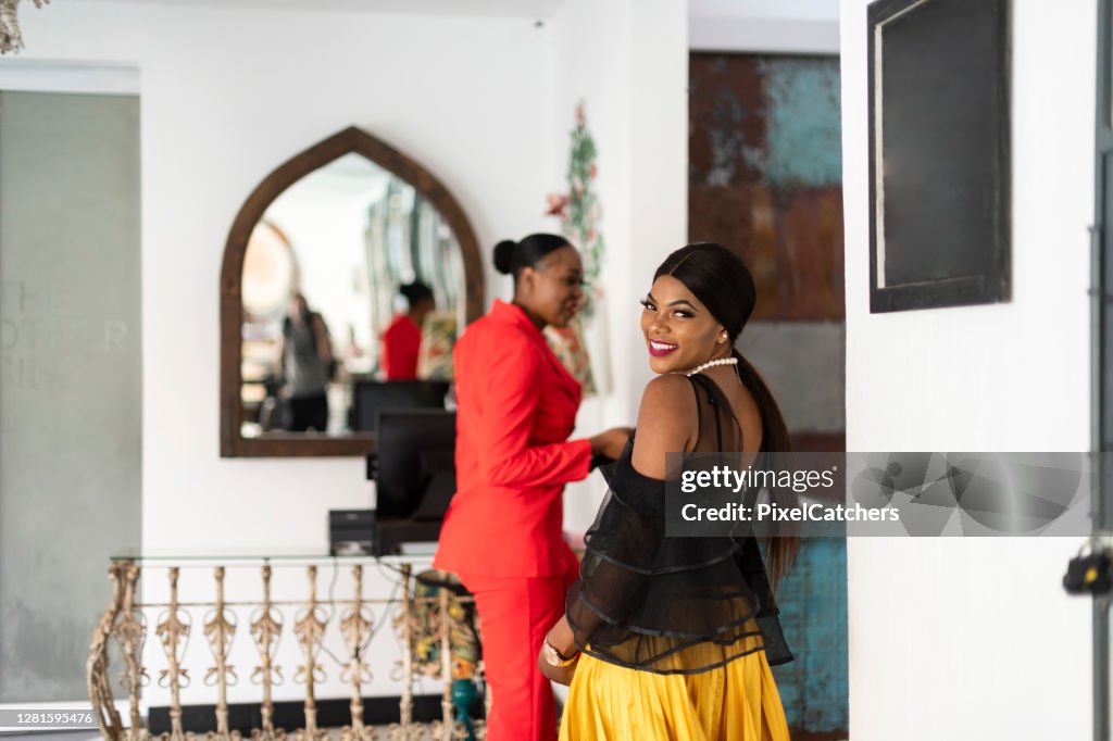 Young African businesswomen ready to enjoy evening at luxury hotel