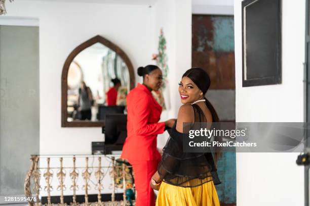 young african businesswomen ready to enjoy evening at luxury hotel - evening wear stock pictures, royalty-free photos & images